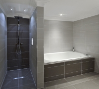 Designer Tiled Bathroom with bath top and hand shower